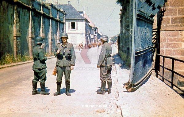 German Wehrmacht soldiers guarding large steel French town fortified gates. France 1940