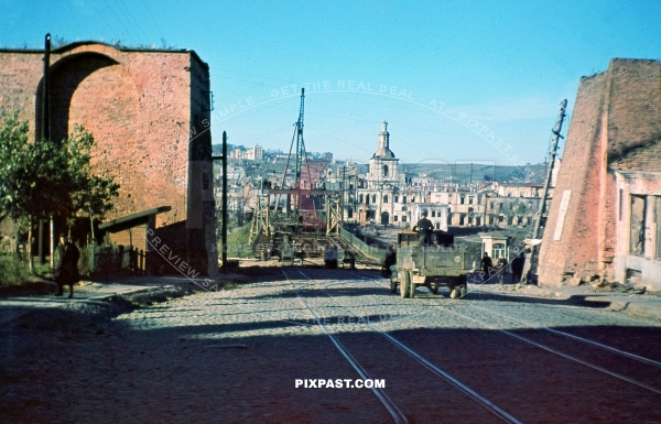 Germans driving captured Russian GAZ truck beside repaired bridge in Smolensk Russia September 1941