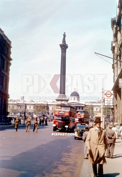 London Red Bus in front of Nelsons Column. Whitehall road. London England 1944. War time.