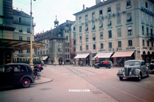 Molard Clock tower in Geneva city center Switzerland 1945. Classic cars. oldtimers. Vans and Hotels.