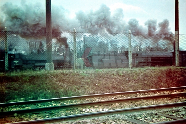 Two large German Reichbahn Steam Locomotive Trains driving cargo in the West train station in Vienna Austria February 1944