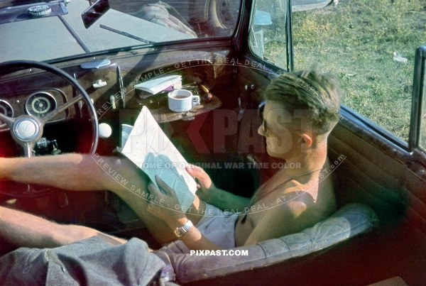 Wehrmacht infantry officer reading newspaper in Opel staff car. Near Stalingrad 1942 summer. 297 Infantry Division. Russia 1942