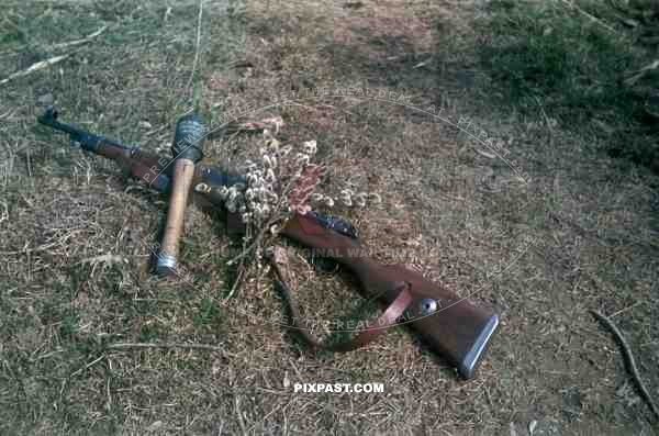 A German soldier photographs his weapons. Polish Russian border summer 1944.