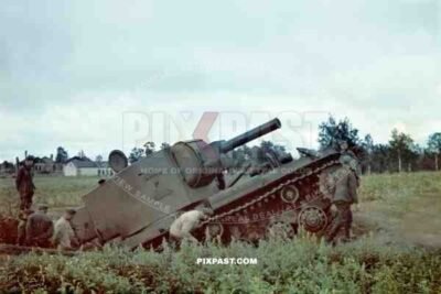 A captured Soviet Russian KV 2 Bunker Buster Heavy Assault Tank. Russian Front 1941. Being inspected by German soldiers.