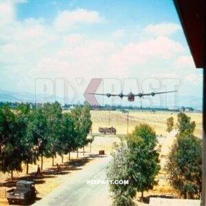 American Consolidated B-24 Liberator bomber plane doing fly by passed hotel in San Giovanni Italy 1944