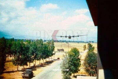 American Consolidated B-24 Liberator bomber plane doing fly by passed hotel in San Giovanni Italy 1944