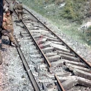 American GI soldiers examining a destroyed railway track near Worms Germany 1945. Rails are destroyed from the Nero order