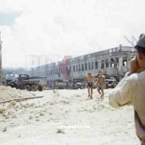 American GMC Jimmy cargo trucks parked outside a blown up Japanese government building. Naha Okinawa 1945