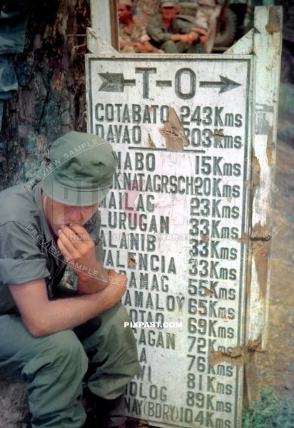 American soldier beside road sign in Malaybalay Bukidnon in Philippines 1944. Thirteenth Expeditionary Air Force 13 EAF