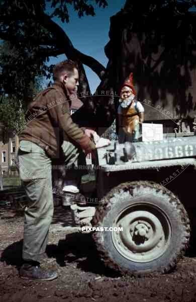 American soldier with german garden gnome. SS Childrens School in Buchenwald Germany 1945.