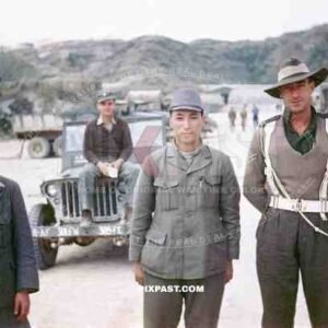 An Australian military police man escorting 2 captured Japanese POW soldiers in Sakishima 1945