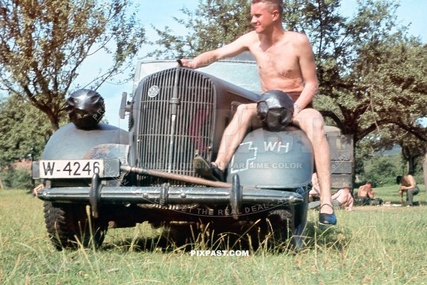 Army driver with his 1938 Opel Super 6 Cabriolet staff car in Russian field. Russia 1941. 297 Infantry Division. W-4246.