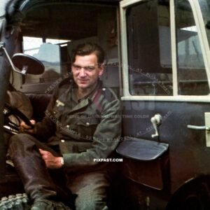Army medical driver with blue shoulder boards sitting inside a leichter Lkw Steyr 640 - Kfz.70. Sevastopol KRIM Russia 1942