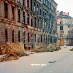 Battle damaged Vienna Austria May 1945. Local School badly damaged with piles of pricks on the road. Austrian flag.