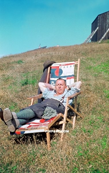 Bavarian hunter with long socks and shorts  resting in sun chair Cacao beside Bodensee Lake Constance in Meersburg 1940