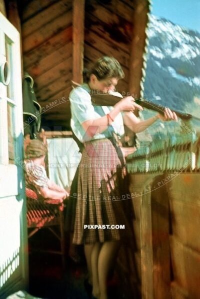 Bavarian wife doing rifle training from the balcony of her home. Meersburg Germany summer 1941