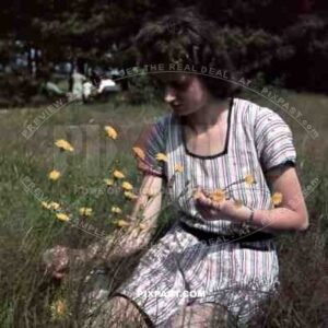 Beautiful woman picking flowers in Berlin Park 1940