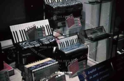 Berlin, 1939, Accordion Music shop window, Consumer Products, service offered in English and french. Odeon