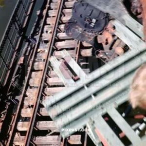 Blown up German train on its side. Under new Bridge transporting American GIs into Worms Germany 1945