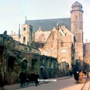 Bombed houses and shops on Burg Strasse in Leipzig 1945. Showing the Thomaskirche in background. Train tracks.