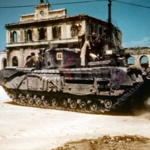 British army Churchill Tank Number 7 driving passed heavily bombed Italian train station. Italy July 1944