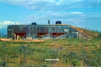 Captured French Maginot Machine Gun Bunker. France July 1940. Barbed wire fence in machine gun MG field