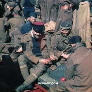 Captures French Military POW soldiers playing cards. Waiting for transport to Prisoner of War Camps in Germany. 1940