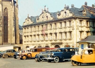Cars and vans parked on Oberer Markt in front of Das Haus zum Falken Das Haus zum Falken and Marienkapelle Wurzburg 1938