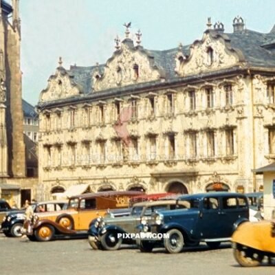 Cars and vans parked on Oberer Markt in front of Das Haus zum Falken Das Haus zum Falken and Marienkapelle Wurzburg 1938