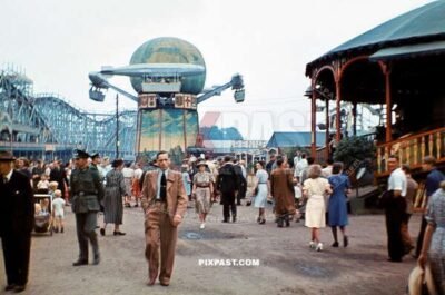 Civilians and soldiers enjoying the arcade games in Parkfest Treptow 1941.  Zeppelin Karussell ride