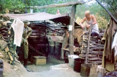Cook wearing tropical uniform cooking with camouflaged thatch Gulaskanone. Bunker Ukraine 1942