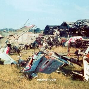 Destroyed French air force fighter planes on landing strip in front of plane hanger. France 1940. Battle of France.