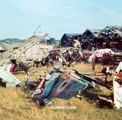 Destroyed French air force fighter planes on landing strip in front of plane hanger. France 1940. Battle of France.