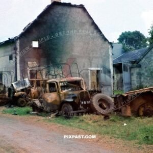 Destroyed French armored car Panhard 178 CDM with a 25 mm gun with army trucks and lorries. road to Dunkirk France 1940