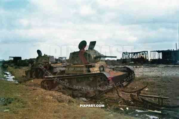 Destroyed Soviet Russian T 26 light infantry tank and a BT 7 cavalry tanks in train station. Russia 1941.