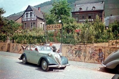 Driving tour 1937 Stoewer Greif Junior Cabriolimousine in front of Brixiade Hotel in Cochem direct on the Moselle Germany 1937