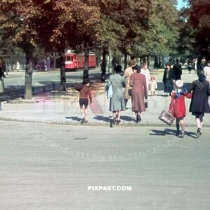 Family bring their children to school. Beside red tram Strassenbahn No. 9. Warsaw Poland summer 1939