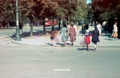 Family bring their children to school. Beside red tram Strassenbahn No. 9. Warsaw Poland summer 1939