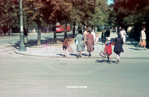 Family bring their children to school. Beside red tram Strassenbahn No. 9. Warsaw Poland summer 1939