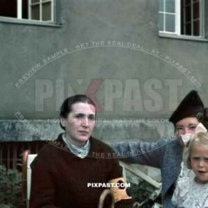 Family visiting a visually impaired relative. Women wears the yellow arm band for visually impaired. Munich Area 1940