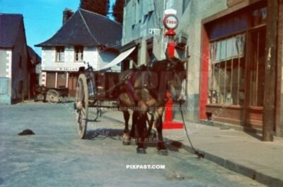 Farmers horse and wagon in front of French Esso petrol station in French village France 1940