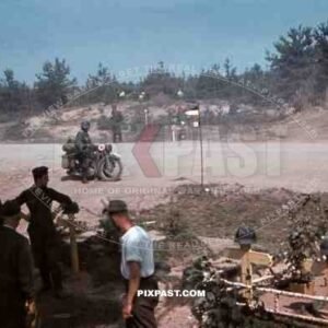 Feldgendarmerie field police with Gorget on motorbike, Cross roads army graveyard with helmets, 19th Panzer Division, 1941