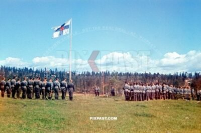 Finnish and Germany army doing a military parade in front of Finish General and Finnish national flag. Finland 1942