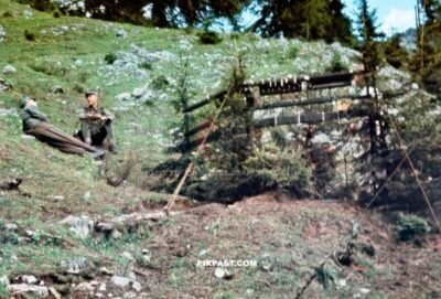 German Gebirgsjager resting beside central radio telephone FUNKER station hidden between the trees 1940