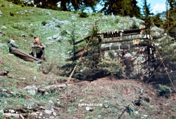 German Gebirgsjager resting beside central radio telephone FUNKER station hidden between the trees 1940