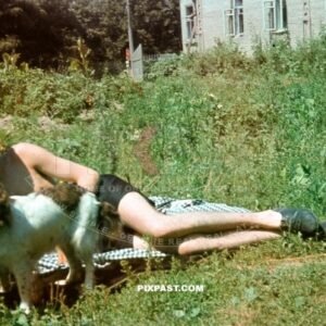 German Gebirgsjager soldier in summer shorts with pet dog Wolfe beside Russian school house. Russia 1942