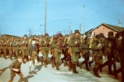German Infantry Regiment wearing M18 helmets marching in Alt Otting in Bavaria Bayern Germany 1940