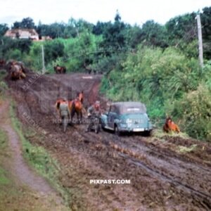 German Kradmelder motorbike messenger and horse cavalry pushing through mud roads. Russia 1942. 297 Infantry Division