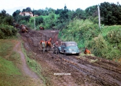 German Kradmelder motorbike messenger and horse cavalry pushing through mud roads. Russia 1942. 297 Infantry Division