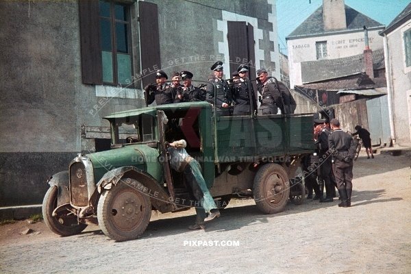 German Luftwaffe FLAK soldiers practicing launching anti aircraft balloons. stand in a french truck. France 1940